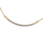Gold necklace with a curved design and small diamonds on a white background
