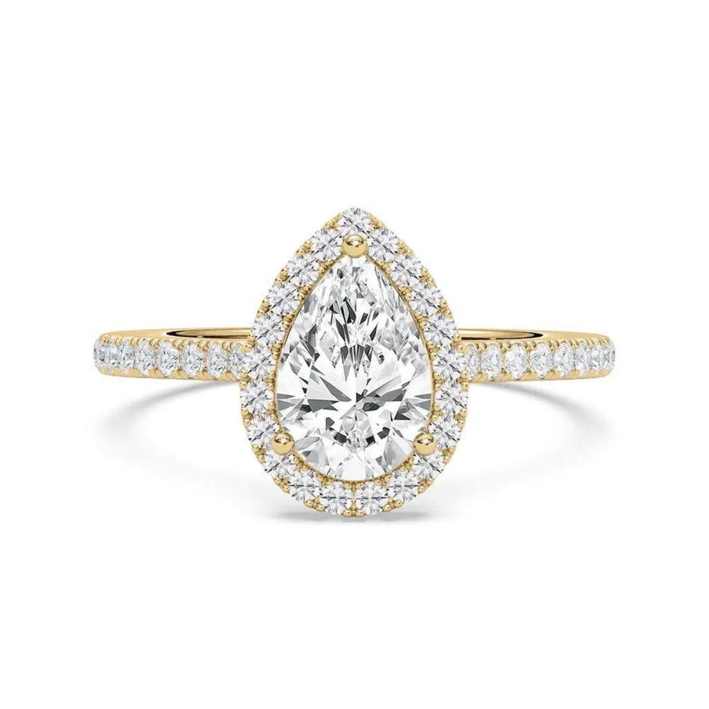 A pear-cut diamond engagement ring in yellow gold with a halo and pavé band, centered on a clean white background.