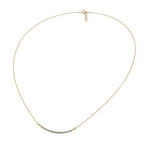 Gold necklace with small diamonds on a white background