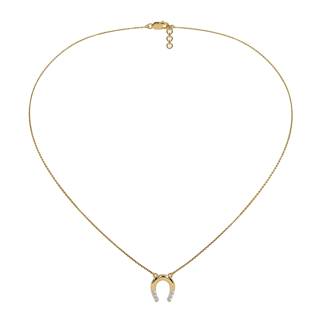 Gold necklace with a horseshoe pendant on a white background