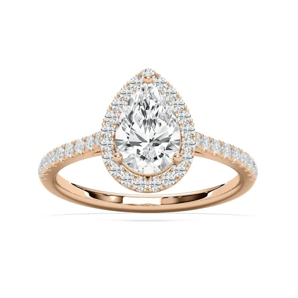 A pear-cut diamond halo ring in rose gold with pavé-set diamonds on the band, shown on a clean white background.