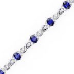 Blue sapphire and round diamond tennis bracelet in White Gold