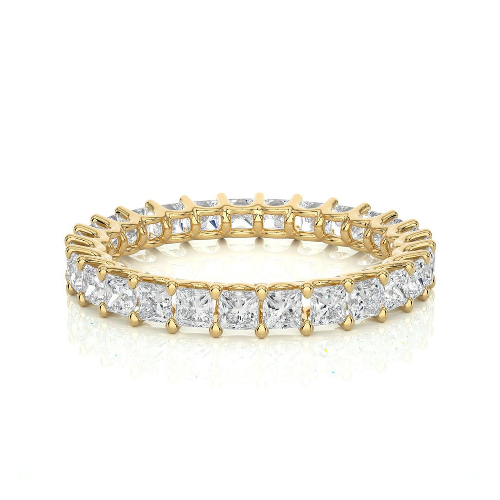 Gold and diamond wedding band on a white background