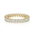 Gold and diamond wedding band on a white background