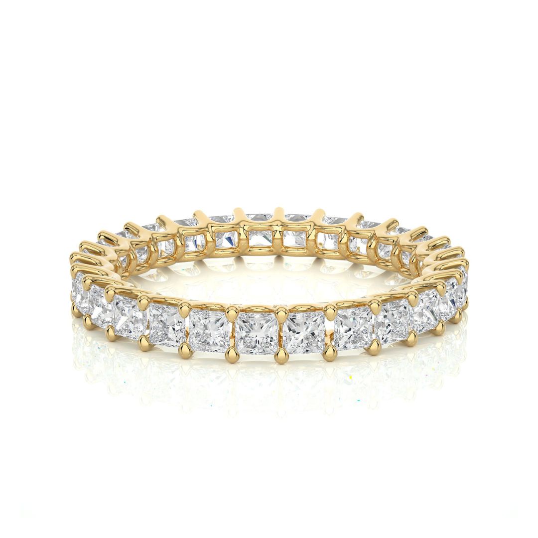Gold and diamond wedding band on a white background