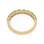 Gold wedding band with embedded stones on a white background