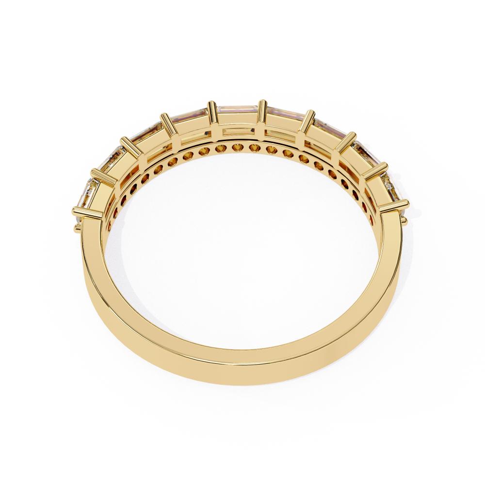 Gold wedding band with embedded stones on a white background