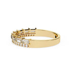 Gold wedding band with diamonds on a white background
