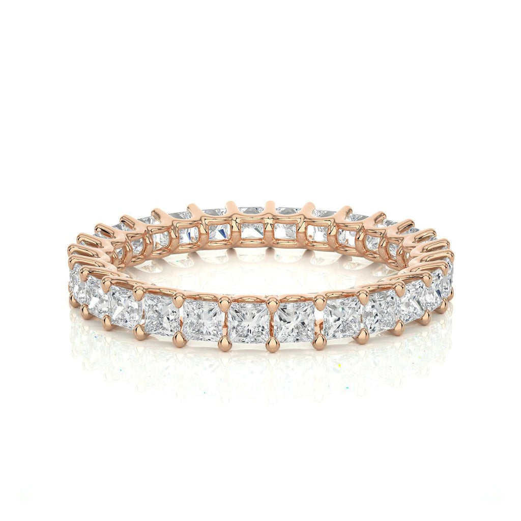 Rose gold diamond wedding ring on a white background