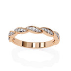 Rose gold wedding band with diamonds on a white background