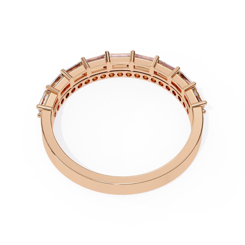 Rose gold wedding ring with embedded stones on a white background