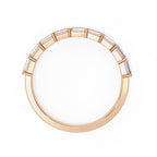 Rose gold wedding ring on a white background