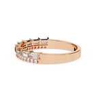 Rose gold ring with diamond accents on a white background