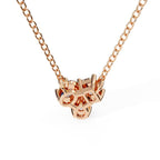 Rose gold necklace with a unique pendant on a white background
