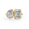 Emerald and pear diamond Toi et Moi bezel engagement ring in gold