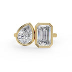 Emerald and pear diamond Toi et Moi bezel engagement ring in gold