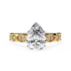Gold Milgrain Cathedral engagement ring with pear shape diamond