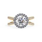 Round halo diamond ring in gold with crossover design