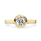 Round brilliant bezel set diamond engagement ring in gold