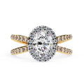 Oval halo diamond ring in gold with crossover design