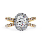 Oval halo diamond ring in gold with crossover design