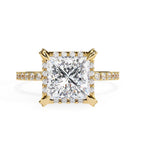 Princess cut diamond halo engagement ring in gold