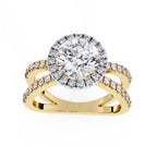 Round halo diamond engagement ring in gold with crossover design