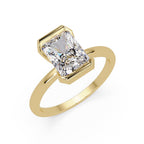 Minimalist gold band featuring radiant-cut solitaire diamond