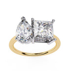 Gold engagement ring with pear and princess lab grown diamonds