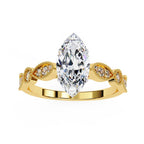 Gold engagement ring with marquise diamond and Milgrain details