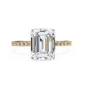 Emerald cut diamond engagement ring with pavé gold band