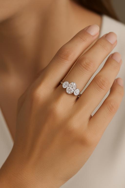 Woman wearing 3 stone oval diamond engagement ring