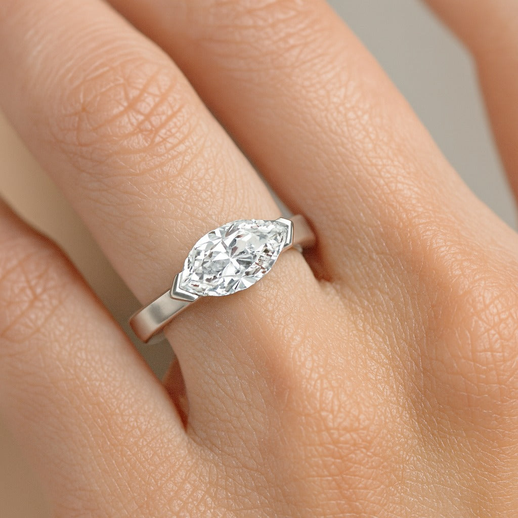 Woman wearing marquise cut diamond engagement ring