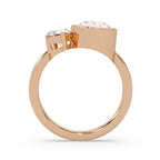 Rose gold ring with two diamonds on a white background