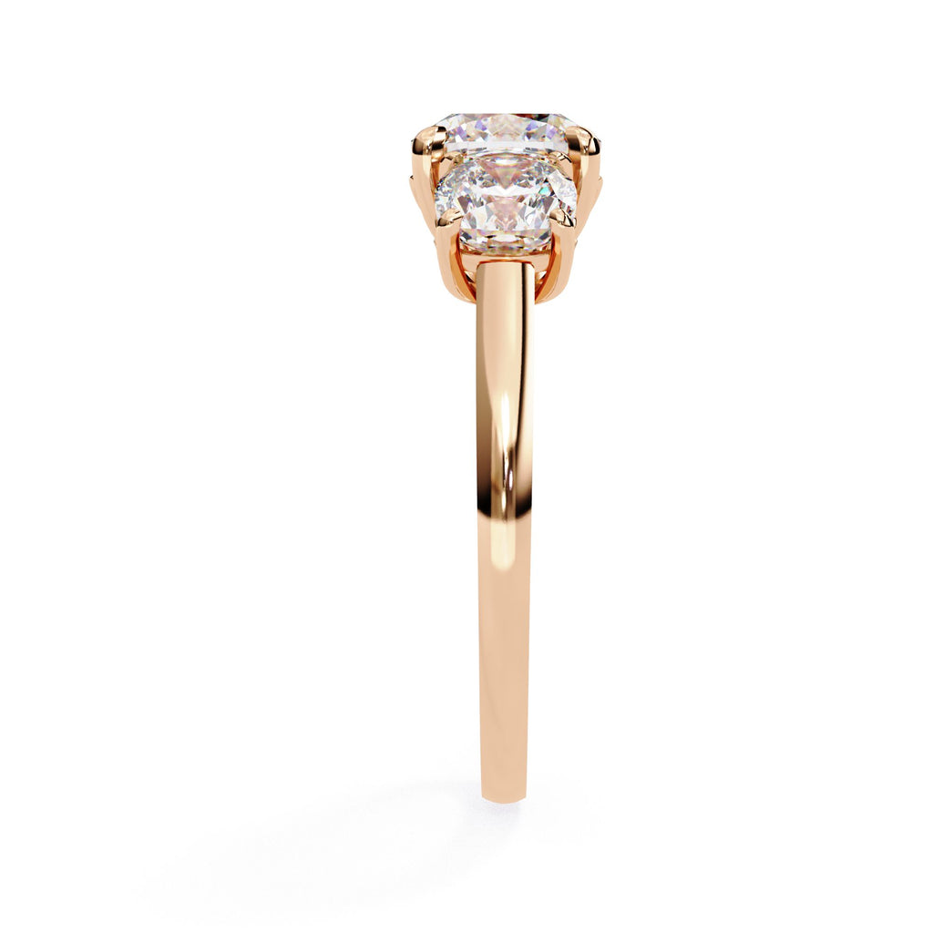 Rose Gold engagement ring featuring three cushion cut diamonds