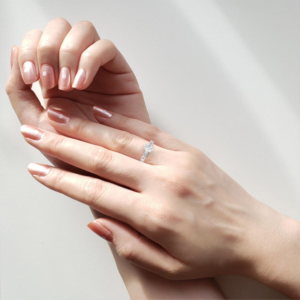 Woman wearing affordable engagement ring with oval shape solitaire diamond