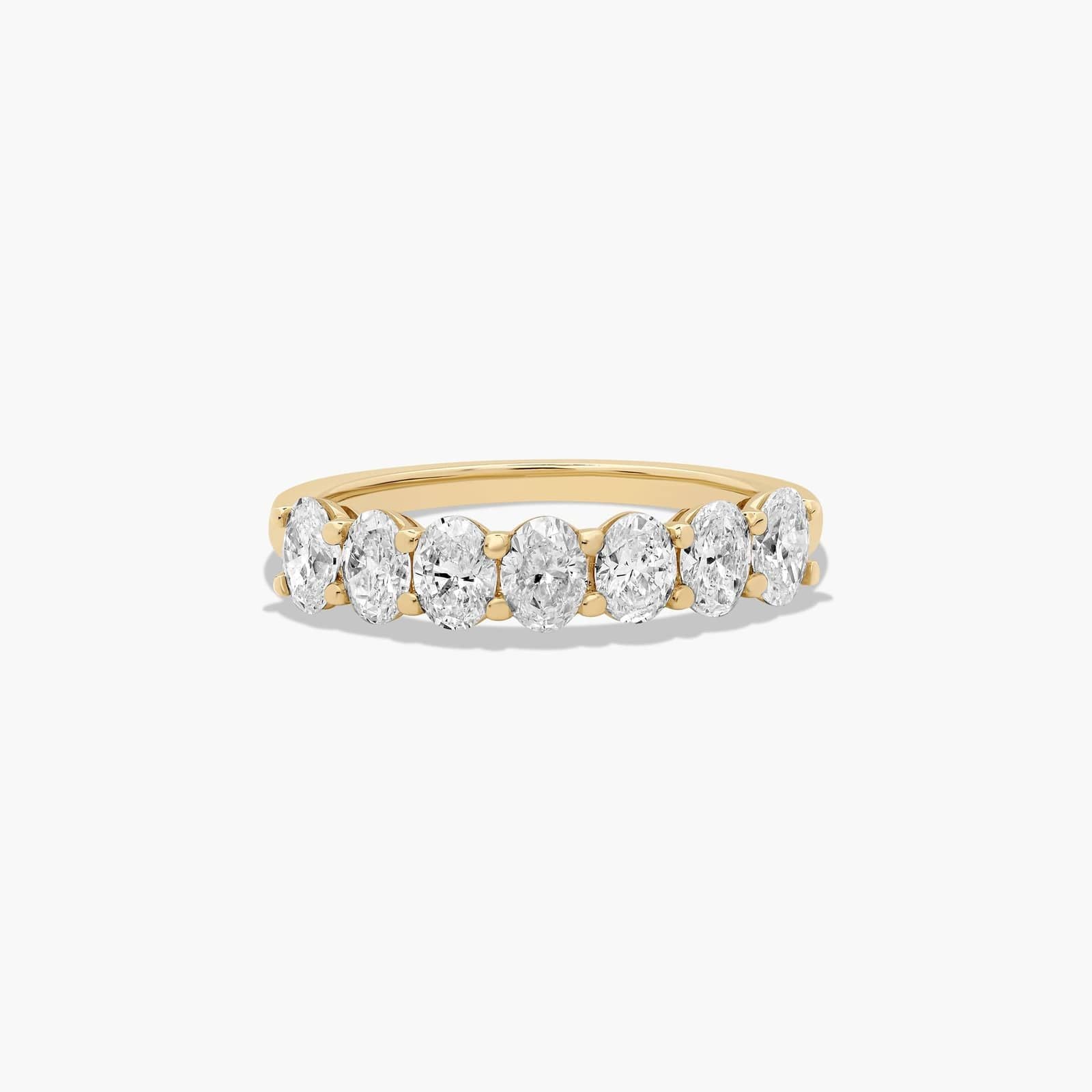 Seven stone oval diamond anniversary ring with elegant gold band