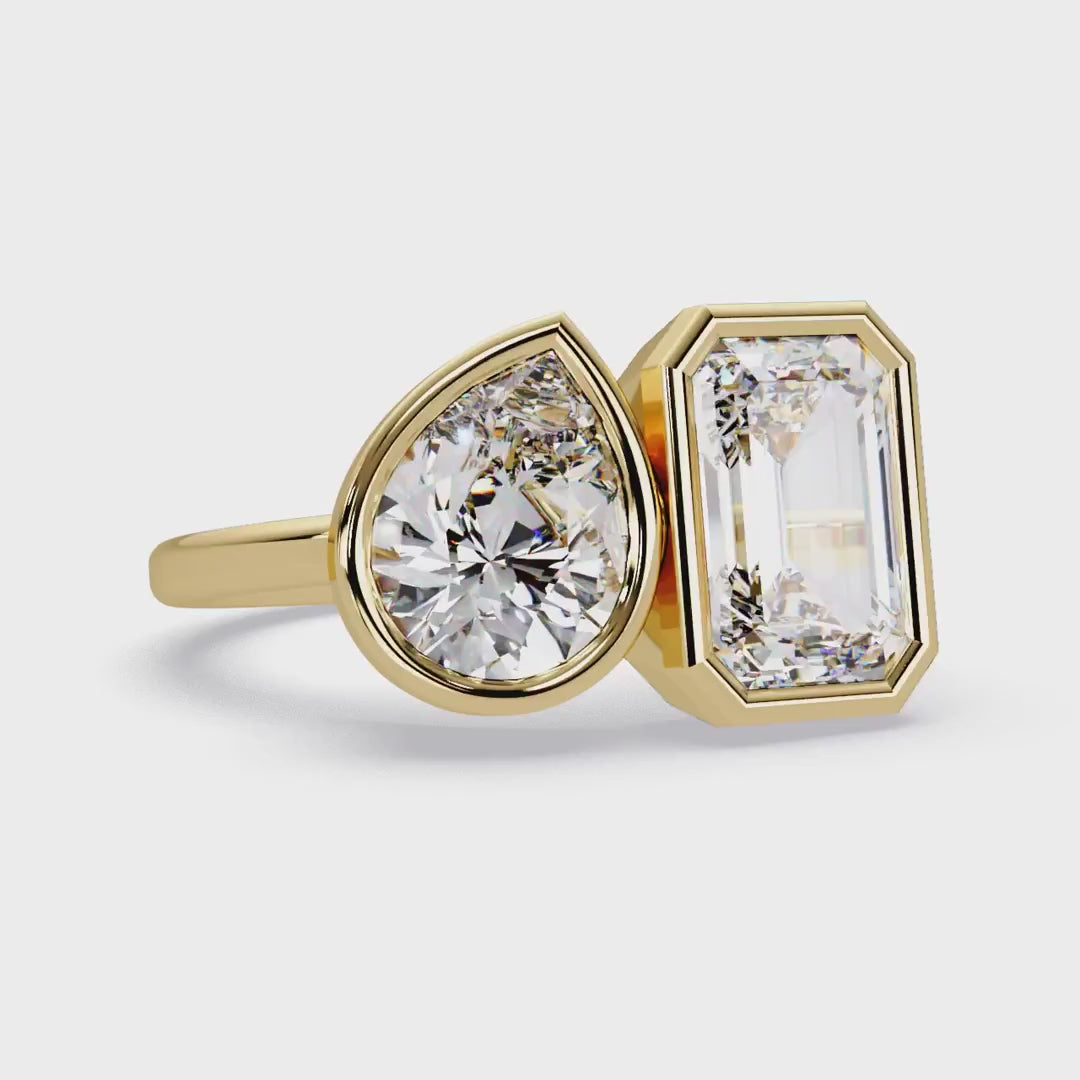 Emerald and pear diamond Toi et Moi bezel engagement ring