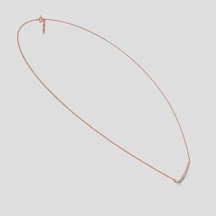 Rose Gold necklace with a curved design and small diamonds on a white background